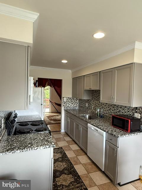 8659 Point Of Woods Dr, Manassas, VA 20110 - kitchen featuring white appliances, gray cabinetry, a sink, ornamental molding, and tasteful backsplash