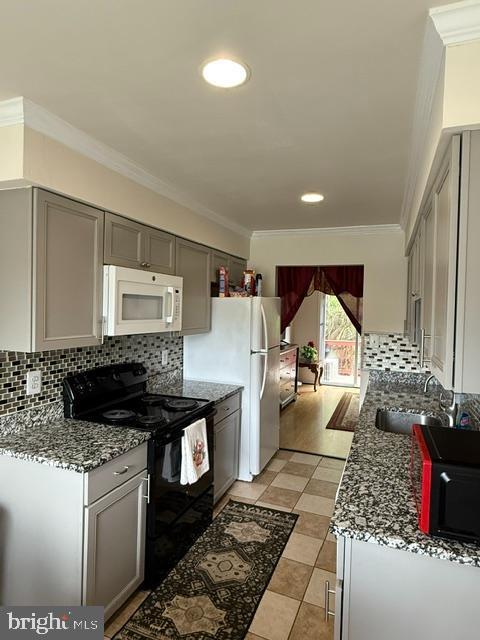 8659 Point Of Woods Dr, Manassas, VA 20110 - kitchen with white appliances, gray cabinets, ornamental molding, backsplash, and a sink