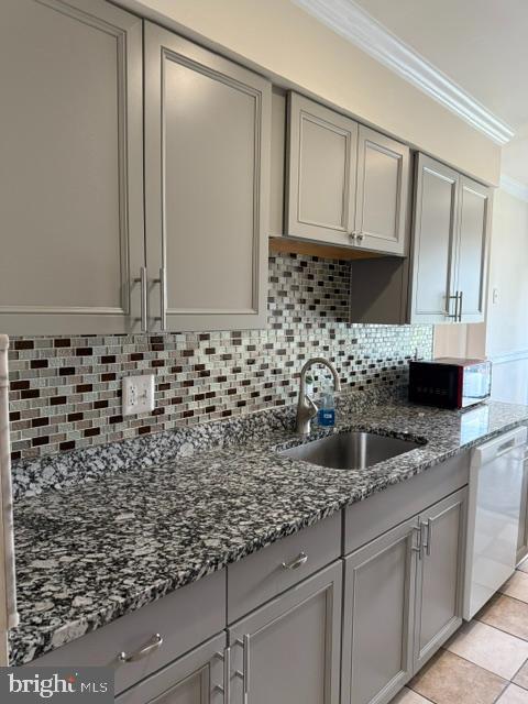 8659 Point Of Woods Dr, Manassas, VA 20110 - kitchen featuring black microwave, gray cabinetry, a sink, white dishwasher, and crown molding