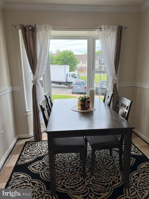 8659 Point Of Woods Dr, Manassas, VA 20110 - dining room featuring baseboards, crown molding, and light tile patterned floors