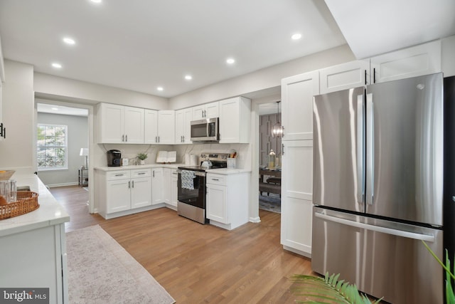 908 Queens Ter, Fort Washington, MD 20744 - kitchen with recessed lighting, light wood finished floors, decorative backsplash, appliances with stainless steel finishes, and white cabinetry