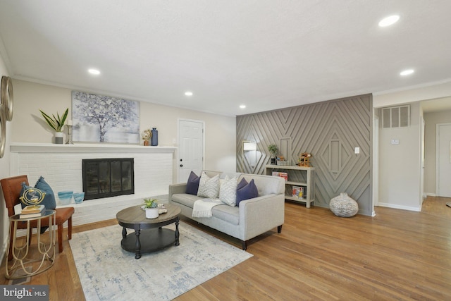 908 Queens Ter, Fort Washington, MD 20744 - living room with a brick fireplace, wood finished floors, visible vents, and recessed lighting