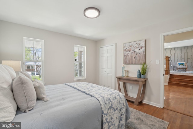 908 Queens Ter, Fort Washington, MD 20744 - bedroom with baseboards, wood finished floors, a closet, and multiple windows