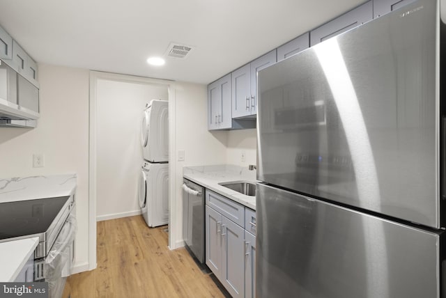 9550 Hagel Cir Unit 10/D, Lorton, VA 22079 - kitchen with gray cabinets, stacked washer and clothes dryer, appliances with stainless steel finishes, and visible vents