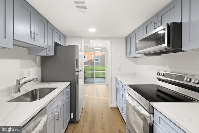 9550 Hagel Cir Unit 10/D, Lorton, VA 22079 - kitchen with light stone counters, appliances with stainless steel finishes, light wood finished floors, a sink, and visible vents