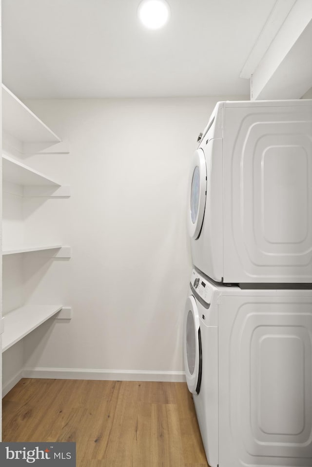 9550 Hagel Cir Unit 10/D, Lorton, VA 22079 - washroom with stacked washer and clothes dryer, light wood finished floors, laundry area, and baseboards