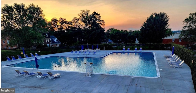 9550 Hagel Cir Unit 10/D, Lorton, VA 22079 - pool at dusk featuring a patio, fence, and a community pool