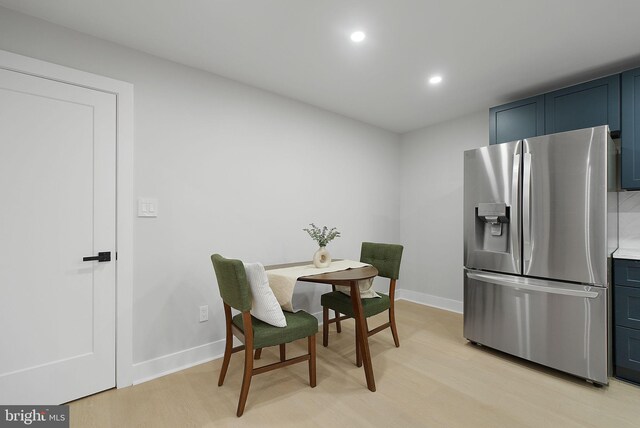 dining space with light wood-style flooring, recessed lighting, and baseboards