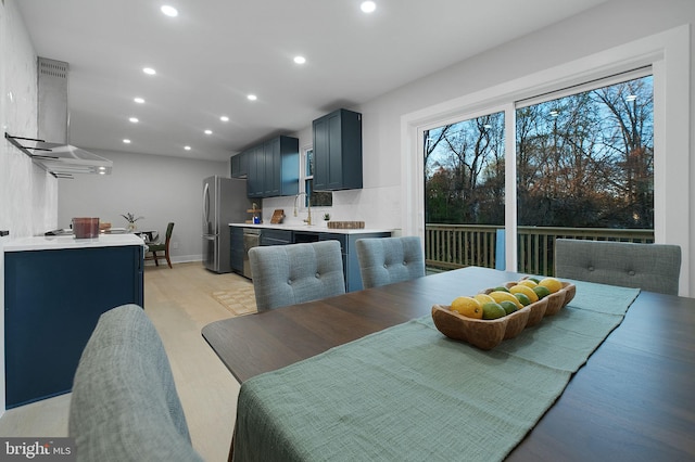 dining space featuring wine cooler, light wood-style flooring, recessed lighting, and baseboards