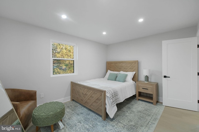 bedroom with baseboards, recessed lighting, and wood finished floors