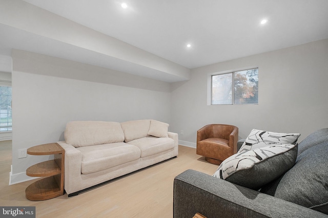 living area with recessed lighting, baseboards, and wood finished floors