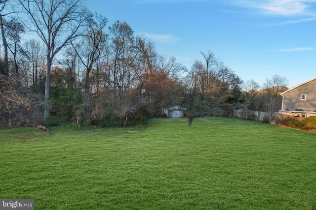view of yard with an outbuilding and a shed
