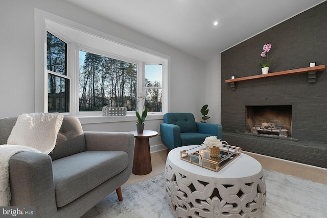living area with recessed lighting, a fireplace, and lofted ceiling