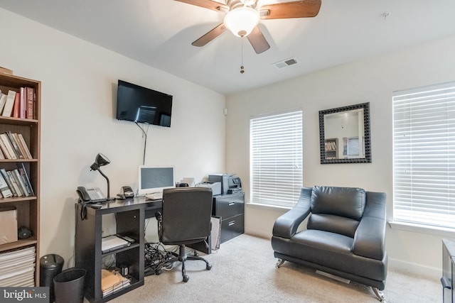 office space featuring visible vents, ceiling fan, carpet flooring, and a wealth of natural light