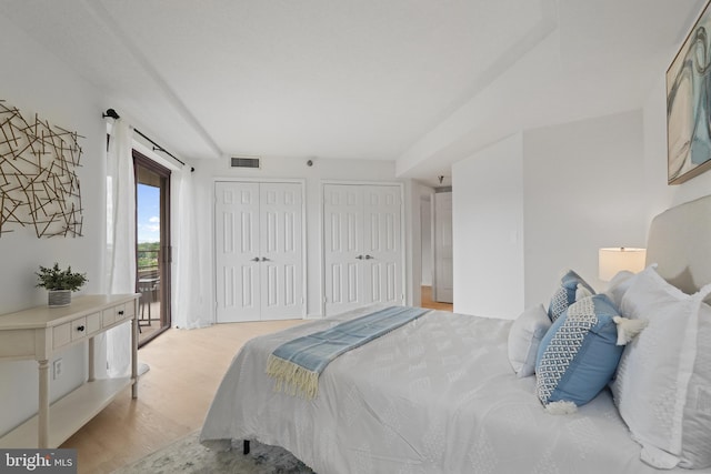 2400 Clarendon Blvd Unit 809, Arlington, VA 22201 - bedroom featuring light wood finished floors, multiple closets, and access to outside