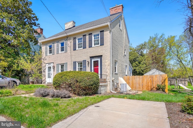 9056 Baltimore St, Savage, MD 20763 - colonial house with fence, central AC unit, and a chimney