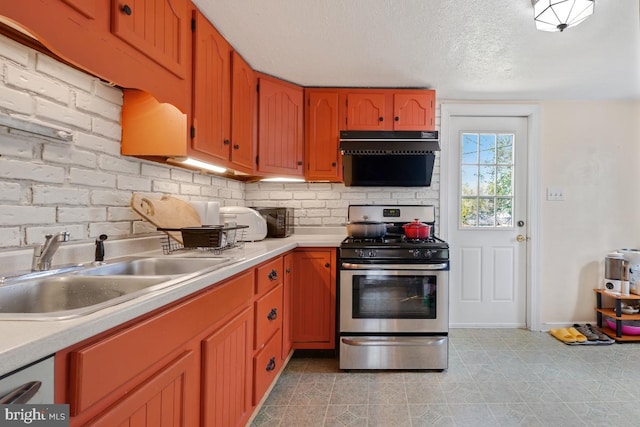 9056 Baltimore St, Savage, MD 20763 - kitchen with gas range, light countertops, a sink, and a textured ceiling