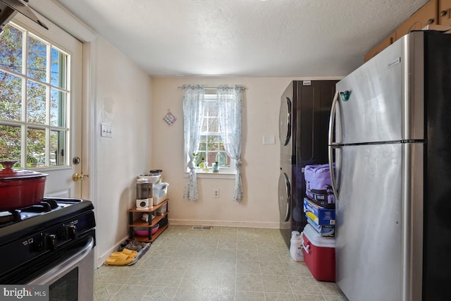 9056 Baltimore St, Savage, MD 20763 - kitchen featuring a textured ceiling, freestanding refrigerator, range with gas stovetop, and a wealth of natural light