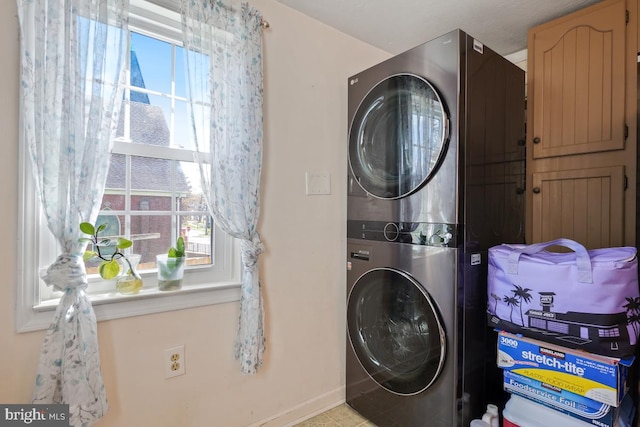 9056 Baltimore St, Savage, MD 20763 - washroom featuring a wealth of natural light, stacked washer / dryer, laundry area, and baseboards