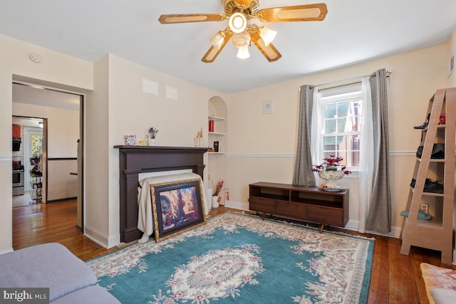 9056 Baltimore St, Savage, MD 20763 - living room with a fireplace, ceiling fan, baseboards, and wood finished floors