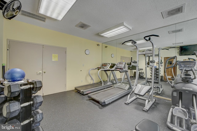 exercise room with a textured ceiling and visible vents