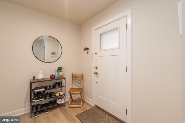 entrance foyer featuring baseboards and light wood finished floors
