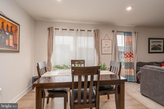 dining room featuring light wood-style flooring, recessed lighting, and baseboards