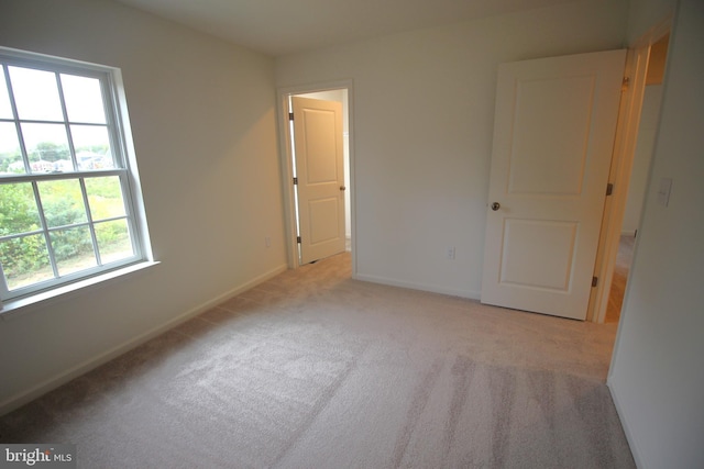 empty room with baseboards and carpet