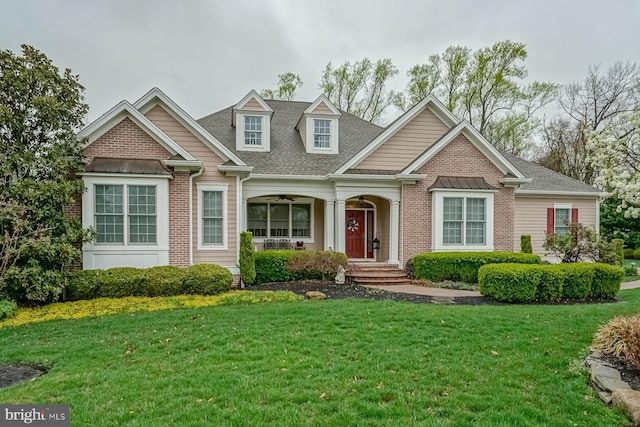 view of front of property with a porch, ceiling fan, a shingled roof, and a front lawn