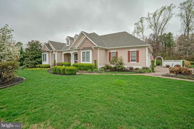 craftsman inspired home with a front lawn