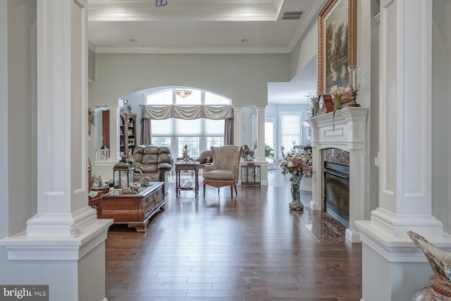 living room with ornate columns, a high end fireplace, visible vents, ornamental molding, and dark wood-style flooring
