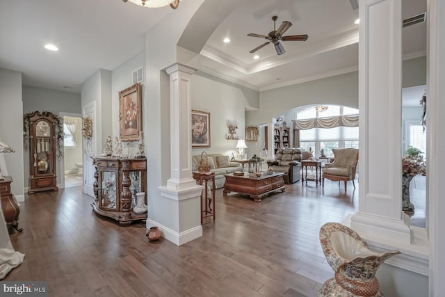 living room featuring arched walkways, visible vents, a healthy amount of sunlight, and decorative columns