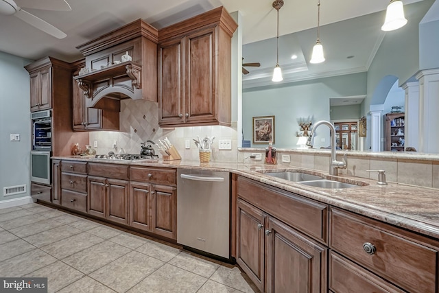kitchen with a ceiling fan, a sink, decorative columns, and appliances with stainless steel finishes