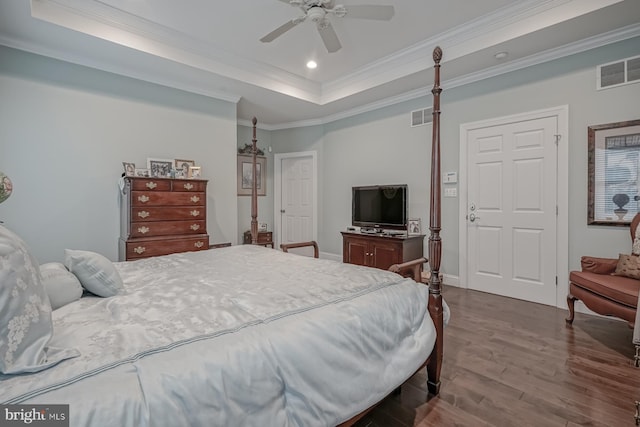 bedroom featuring crown molding, visible vents, a raised ceiling, dark wood-style floors, and recessed lighting
