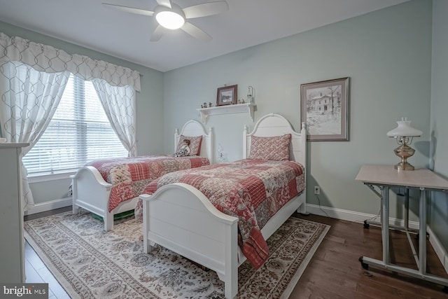 bedroom with ceiling fan, baseboards, and wood finished floors
