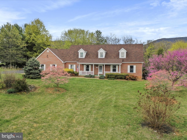 449 Fairview Cir, Woodstock, VA 22664 - cape cod-style house with a front lawn, brick siding, a porch, and a shingled roof