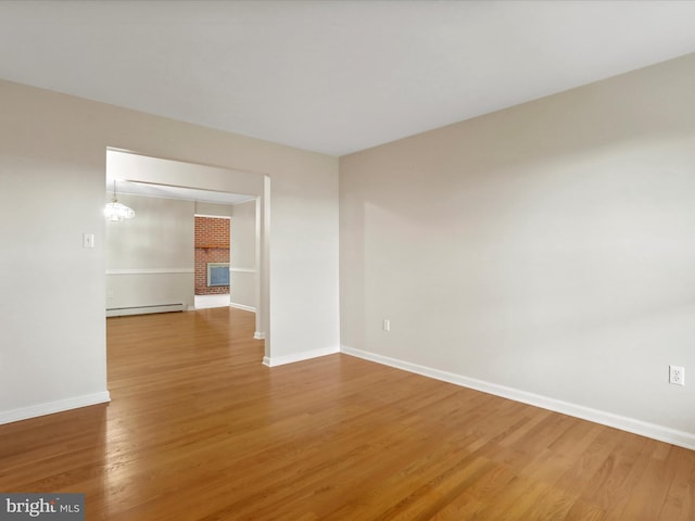 449 Fairview Cir, Woodstock, VA 22664 - spare room featuring a baseboard heating unit, wood finished floors, and baseboards