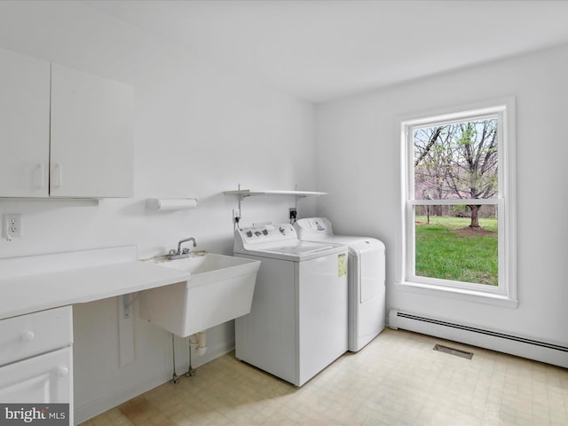 449 Fairview Cir, Woodstock, VA 22664 - washroom with a baseboard heating unit, visible vents, cabinet space, light floors, and washer and dryer
