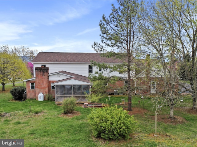 449 Fairview Cir, Woodstock, VA 22664 - rear view of house featuring a chimney, a sunroom, and a lawn