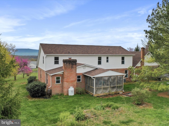 449 Fairview Cir, Woodstock, VA 22664 - back of house with roof with shingles, a chimney, brick siding, a yard, and a sunroom