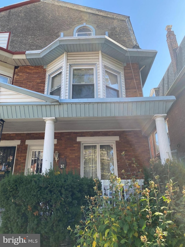 view of property exterior with covered porch