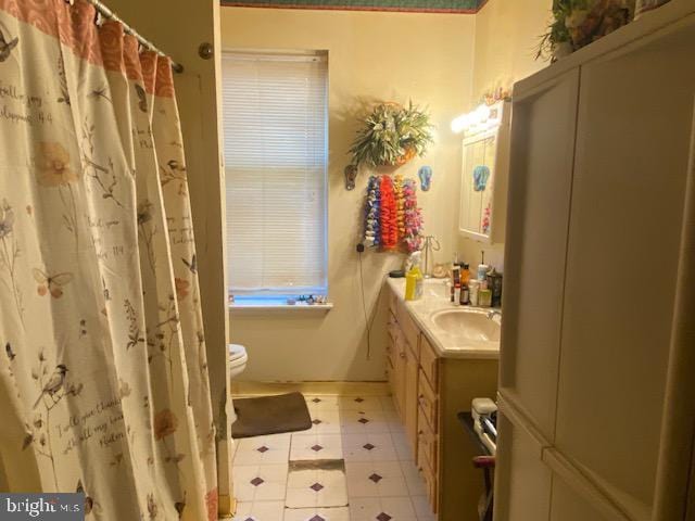 bathroom featuring vanity, toilet, and tile patterned floors