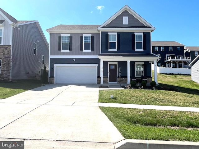 5740 Stone School Ln, Frederick, MD 21704 - view of front facade featuring a porch, stone siding, a front lawn, an attached garage, and concrete driveway