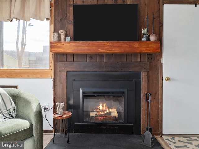 interior details with a glass covered fireplace