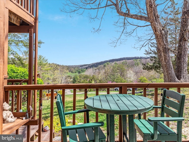 balcony featuring a view of trees