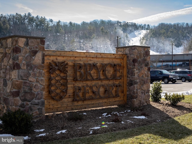 community sign featuring a view of trees
