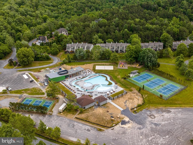birds eye view of property with a wooded view