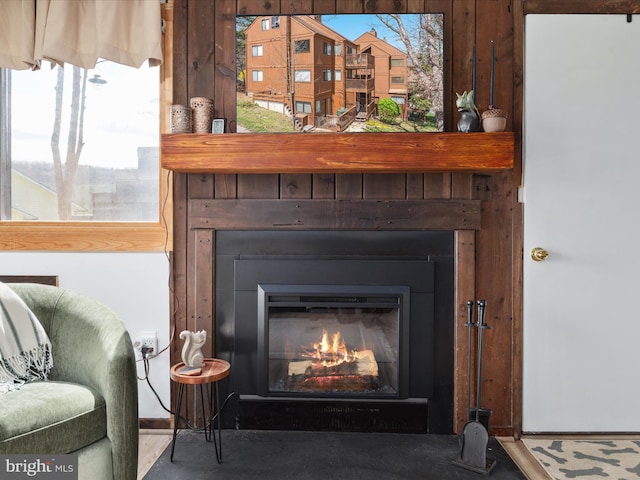interior details with a glass covered fireplace