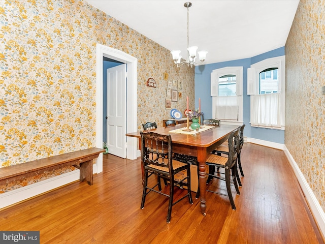 36 Fulton Ave, Walkersville, MD 21793 - dining area featuring a notable chandelier, wallpapered walls, and wood finished floors