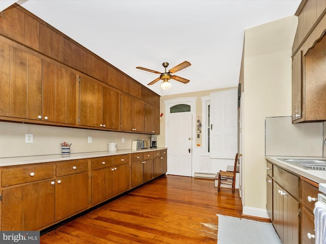 36 Fulton Ave, Walkersville, MD 21793 - kitchen with a ceiling fan, light countertops, brown cabinetry, and dark wood-type flooring